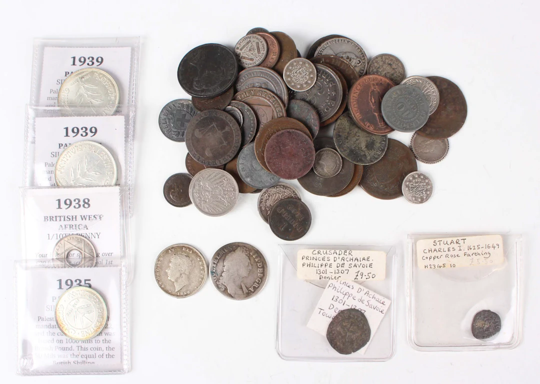 A collection of mixed European and world coins and paranumismatic