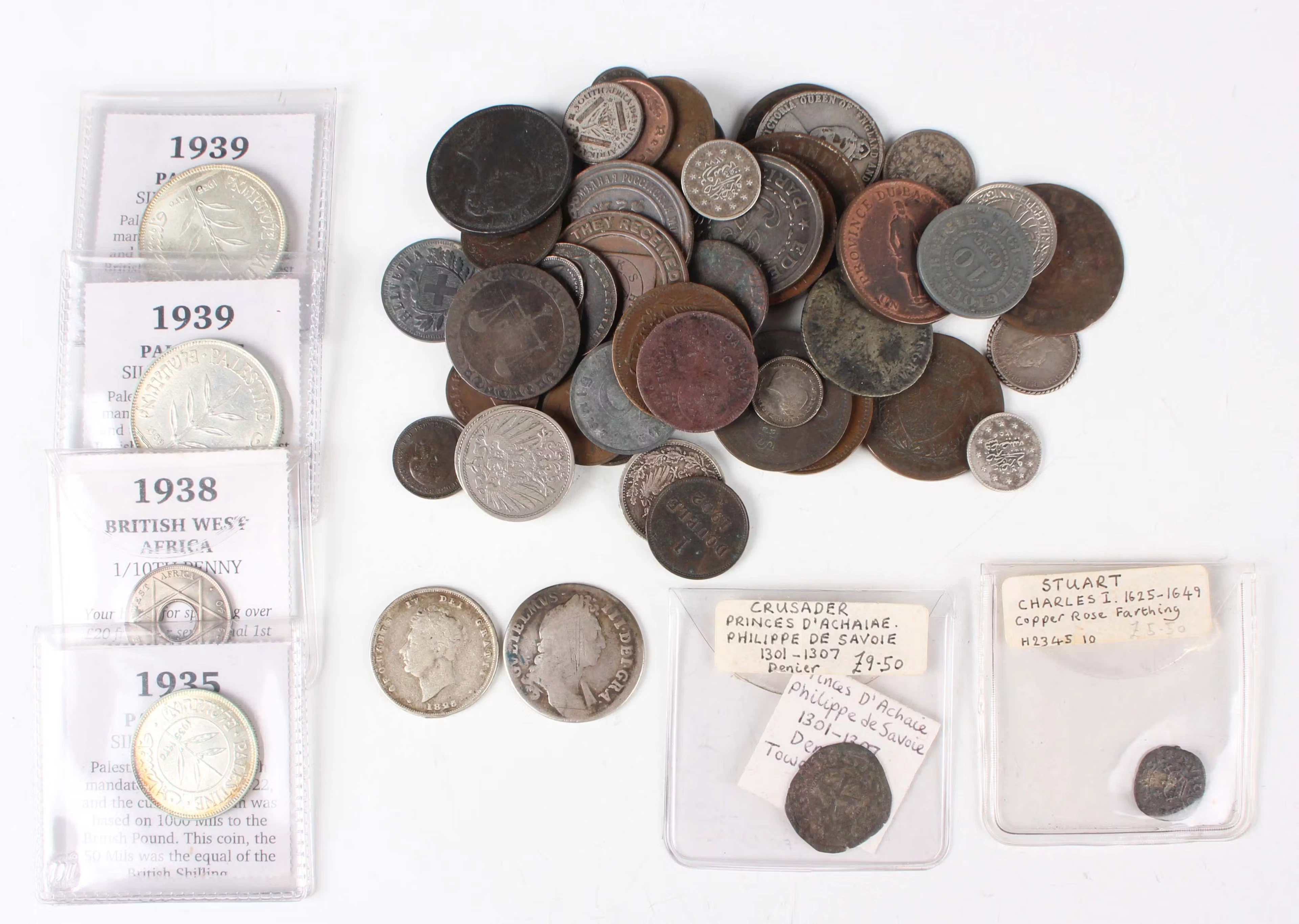 A collection of mixed European and world coins and paranumismatic
