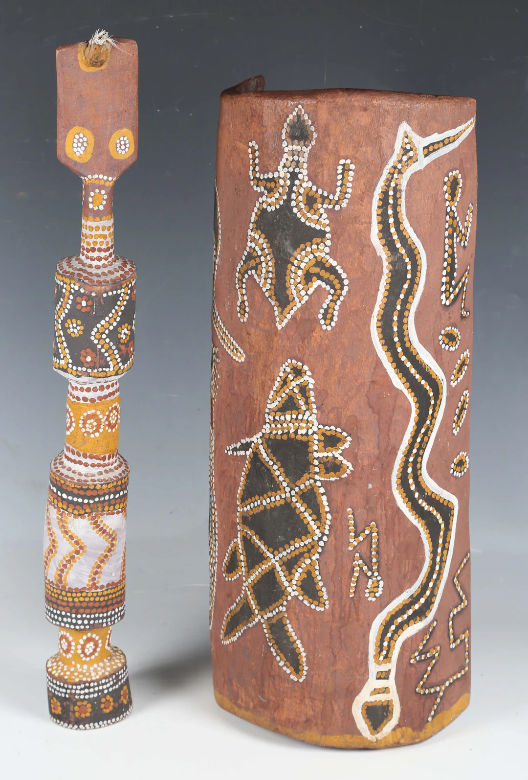 An Australian Aboriginal painted and curved wooden coolamon, decorated