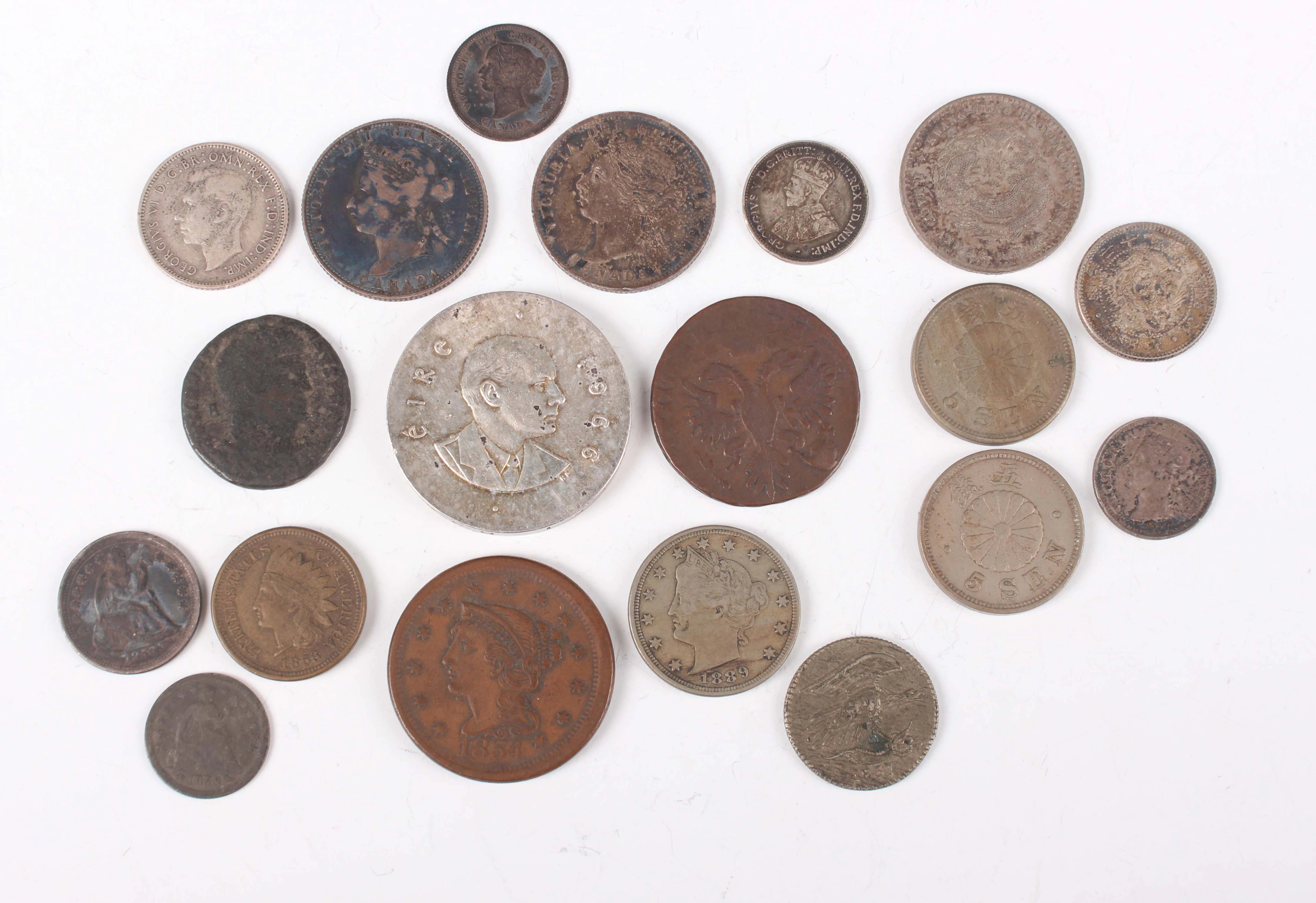 A group of nineteen world coins, including a USA large cent 1854