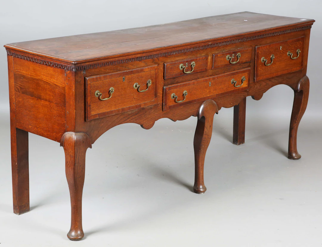 A George III North Country oak dresser base with crossbanded and chequer