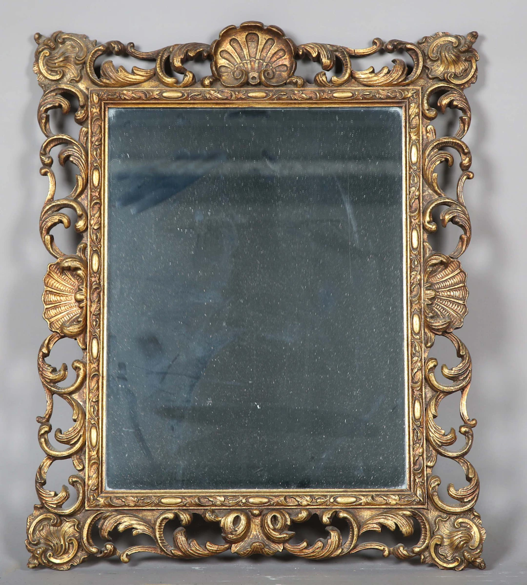 A mid-20th century gilt composition rectangular wall mirror with a