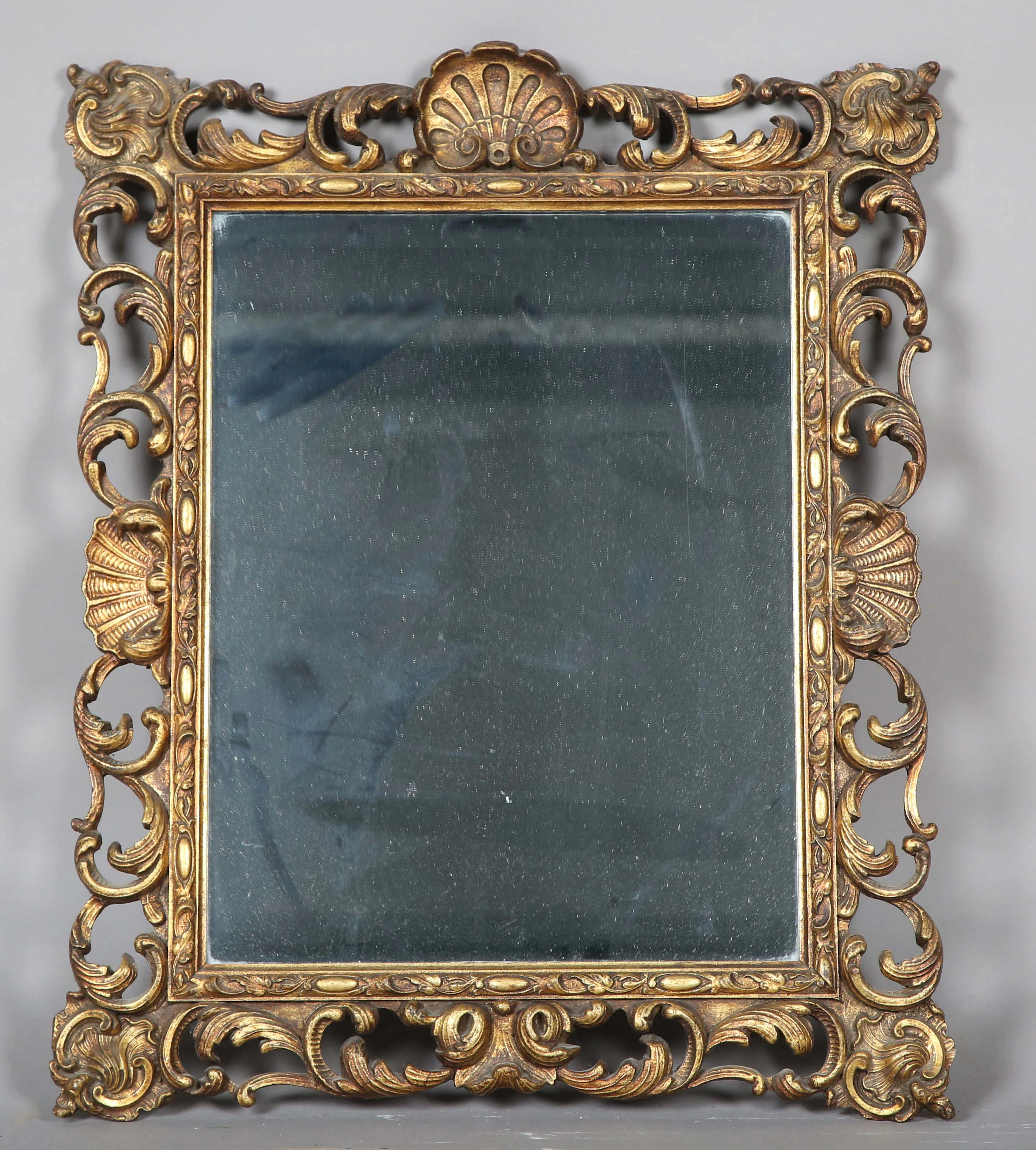 A mid-20th century gilt composition rectangular wall mirror with a