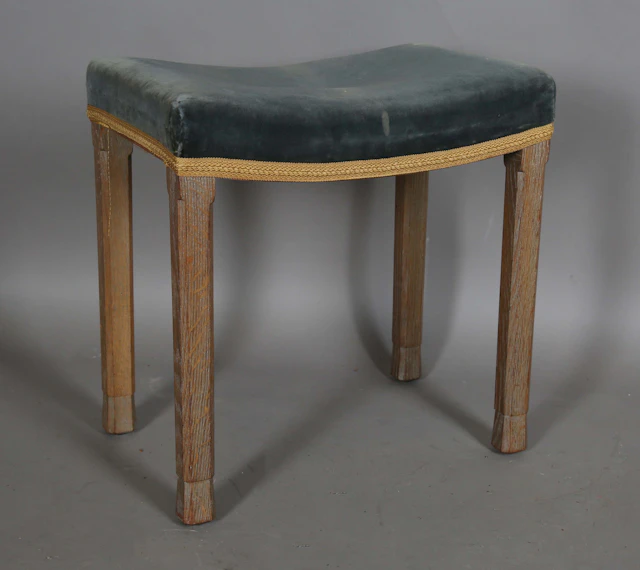 An Elizabeth II limed oak coronation stool with blue velvet seat