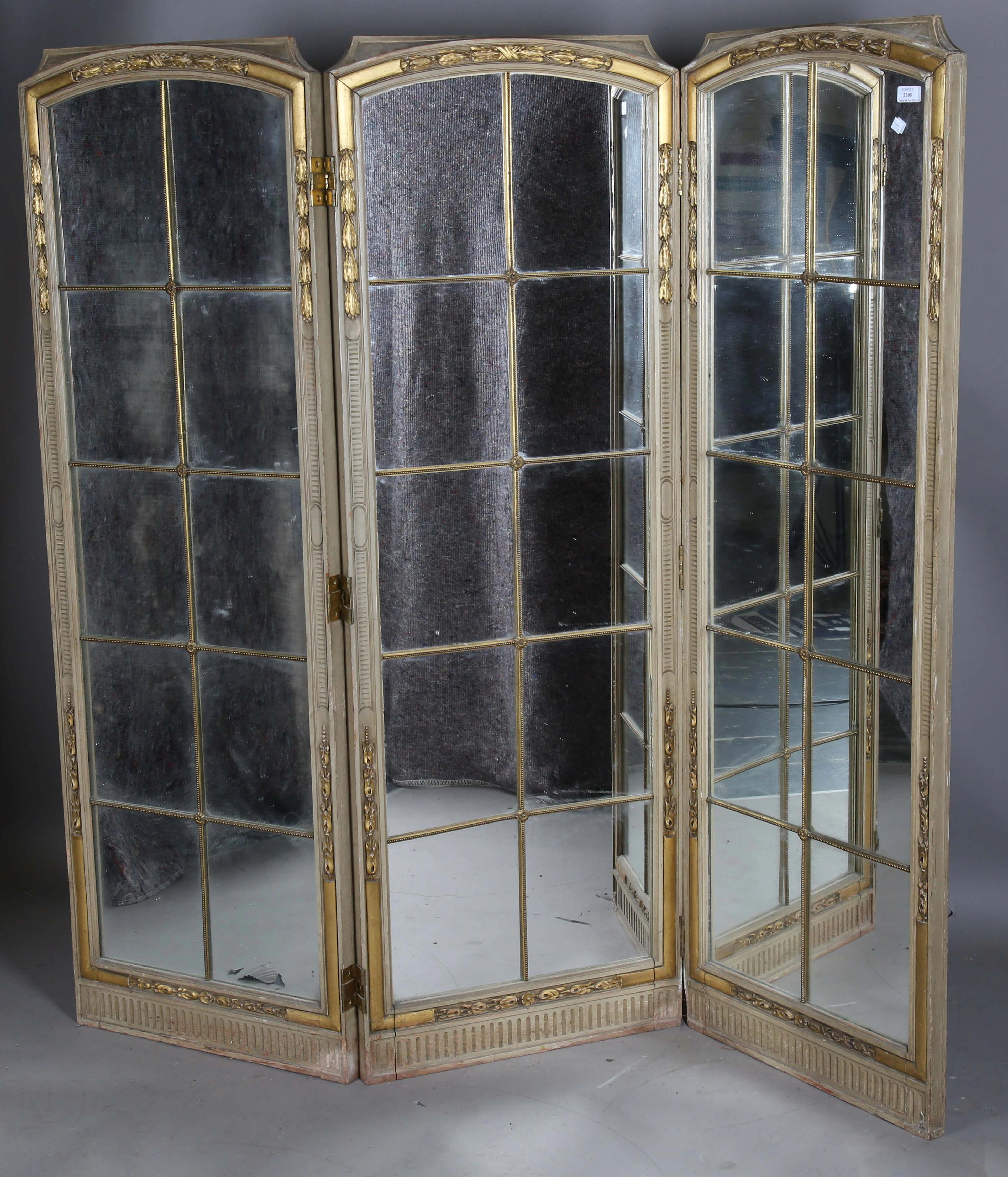 An early 20th century French painted and parcel gilt three-fold dressing