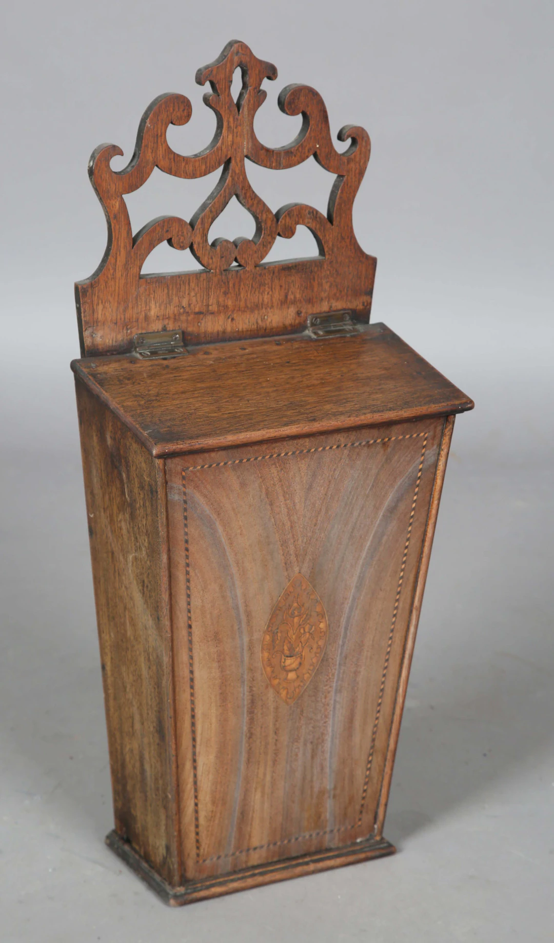 A George III faded mahogany wall-mounted candlebox with inlaid urn
