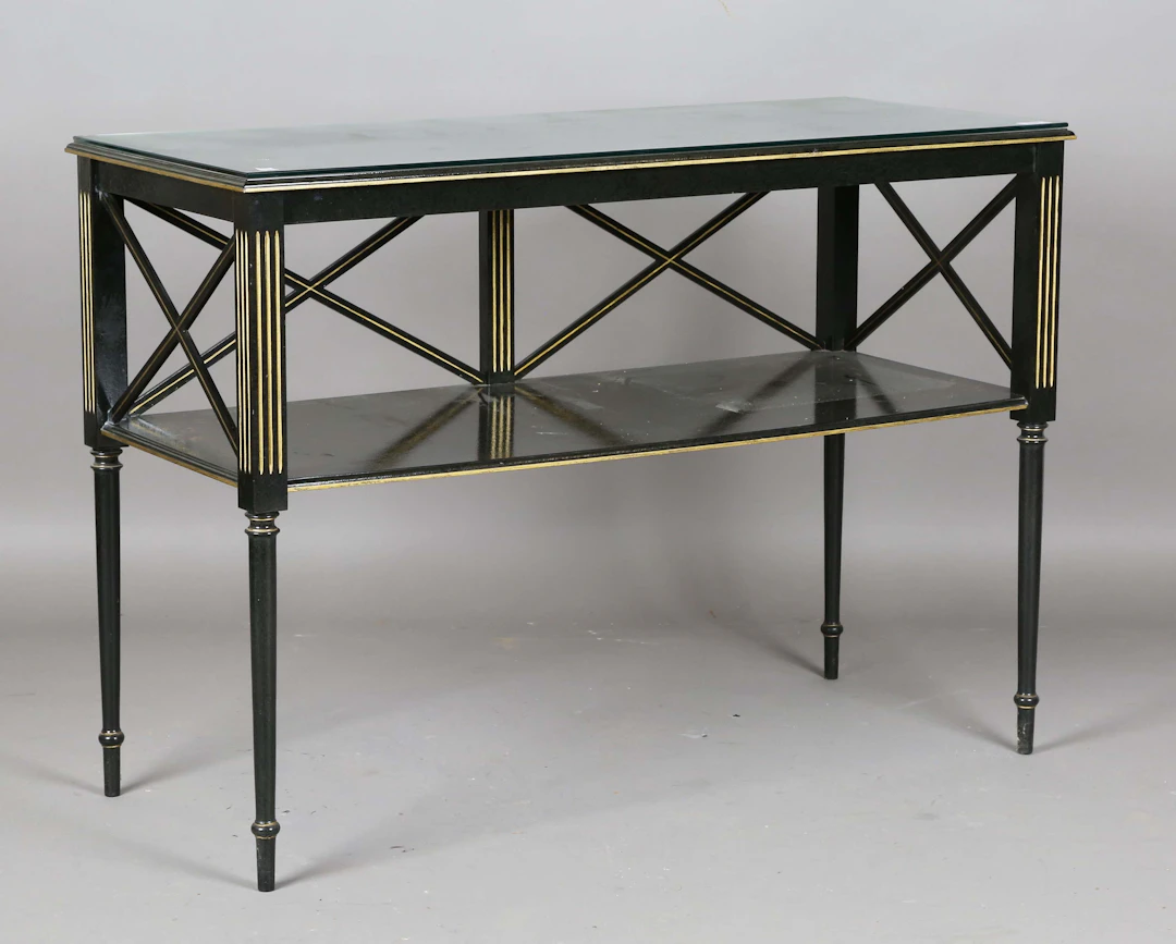 A 20th century black painted two-tier side table with gilt painted