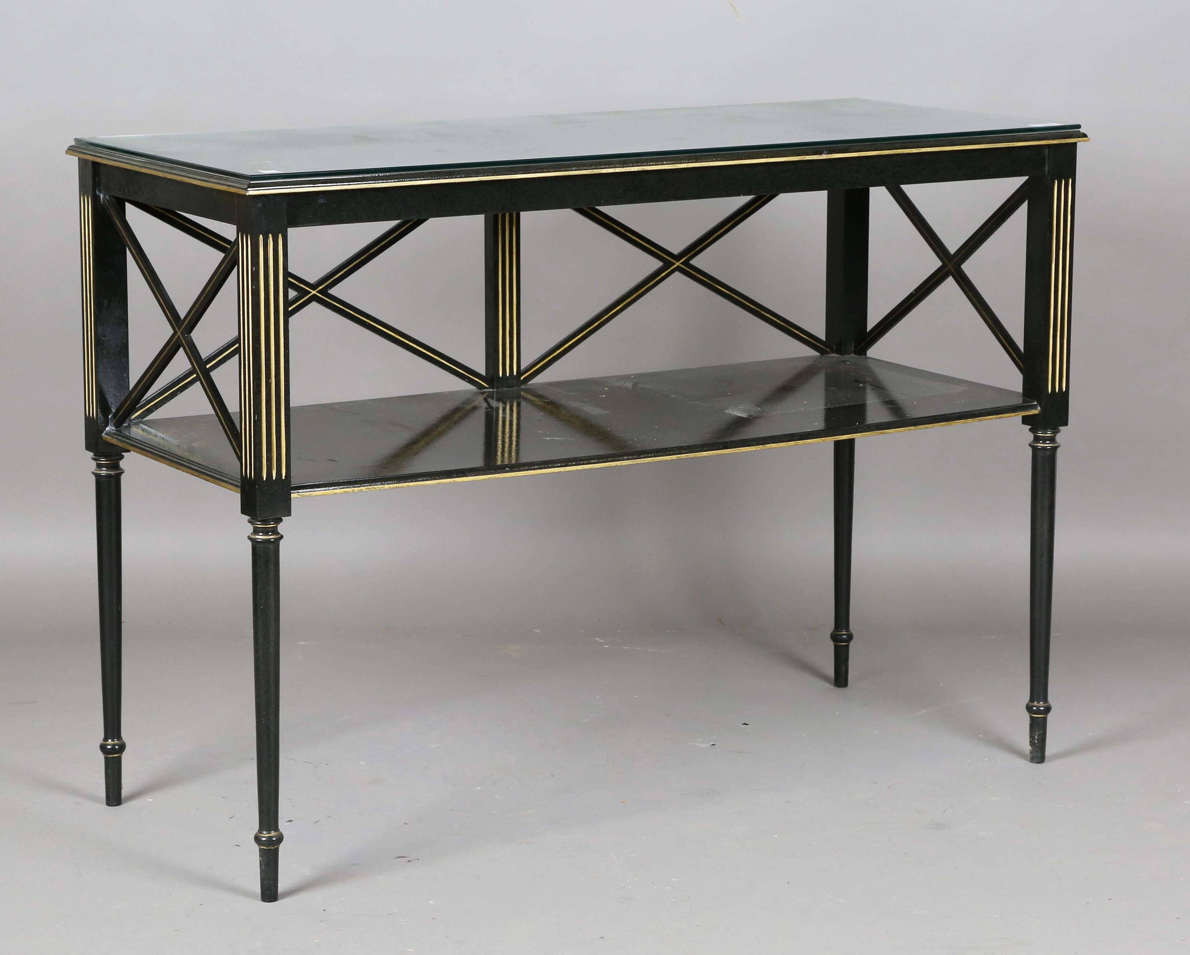 A 20th century black painted two-tier side table with gilt painted