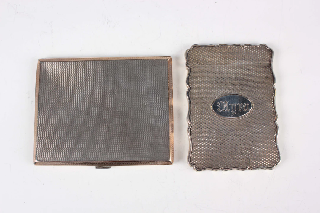 A Victorian silver rectangular card case with wavy outline, the front