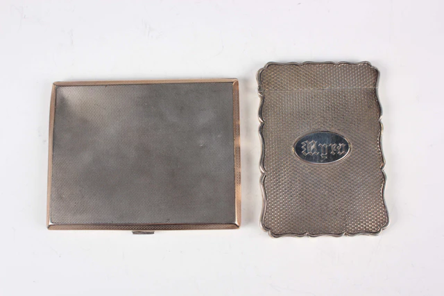 A Victorian silver rectangular card case with wavy outline, the front
