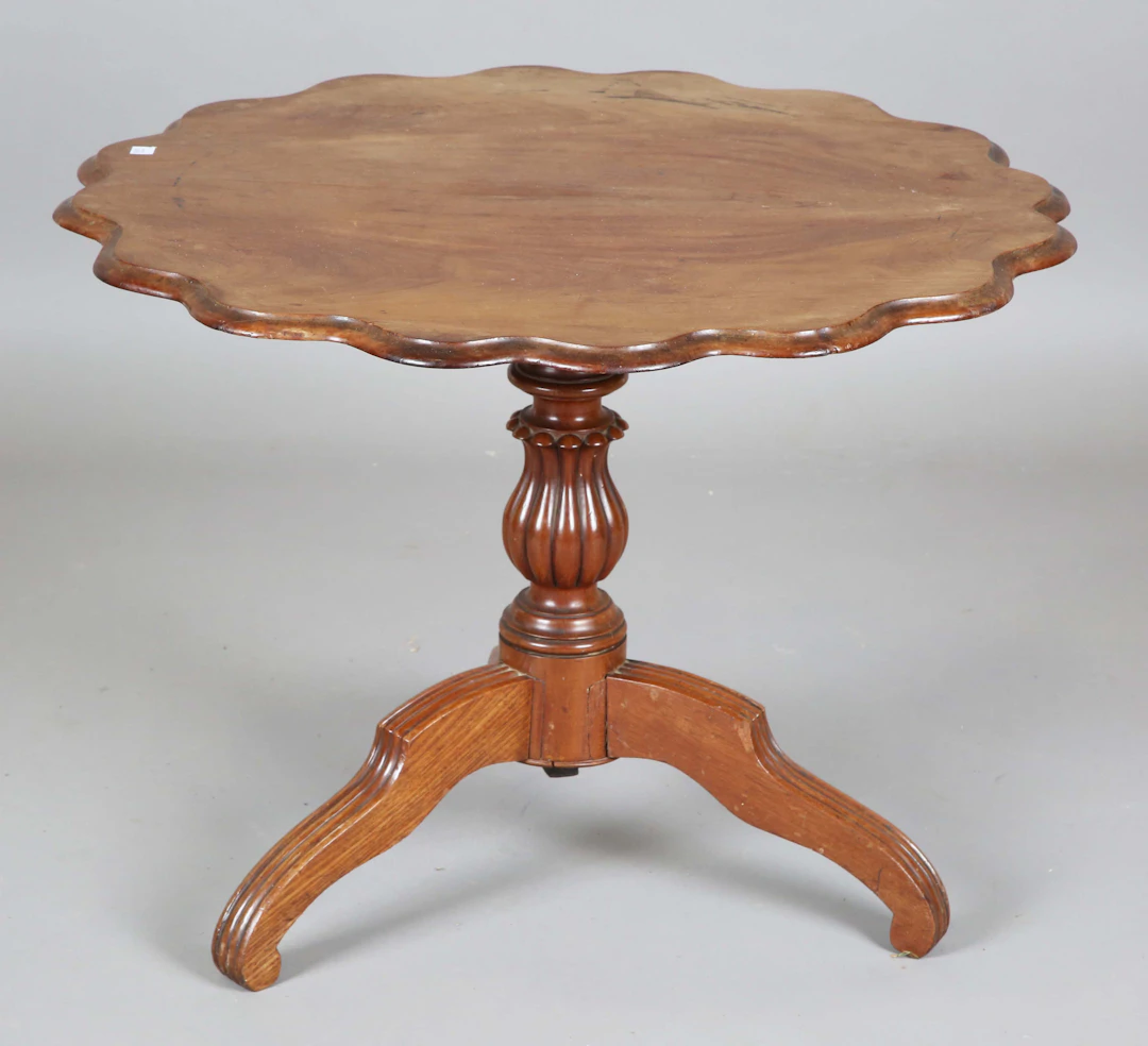 A late 19th century French walnut shaped circular occasional table