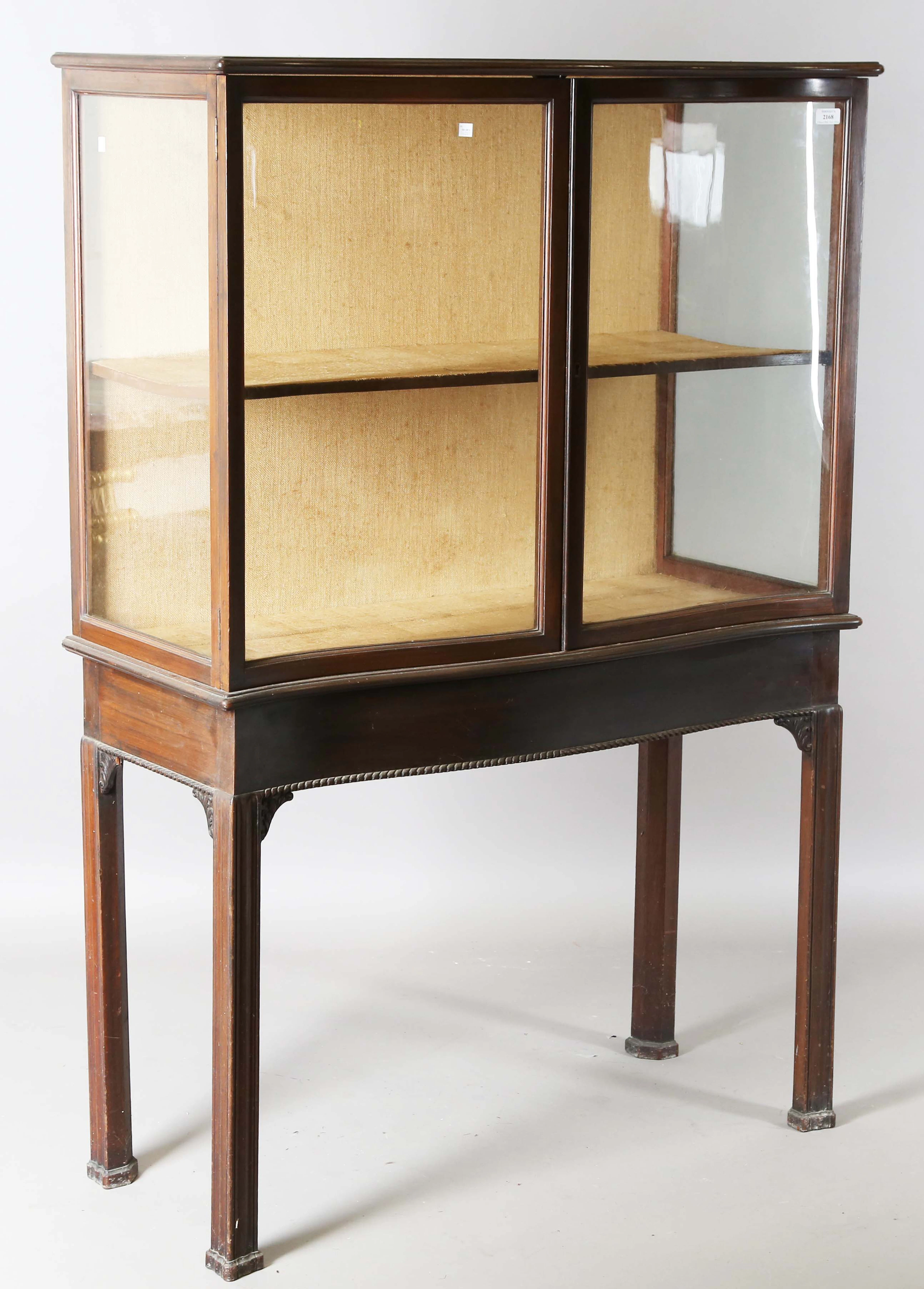 An early 20th century mahogany display case, fitted with a pair of