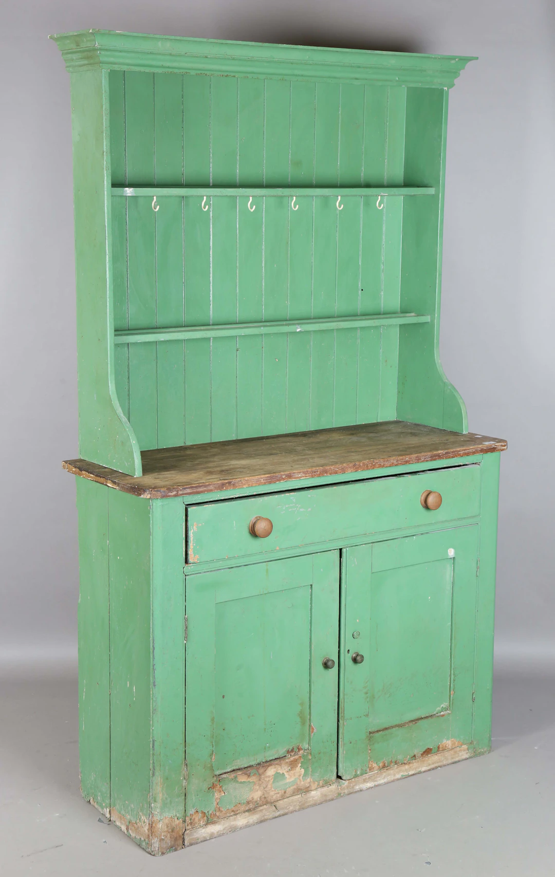 A Victorian green painted pine kitchen dresser base with a later-made