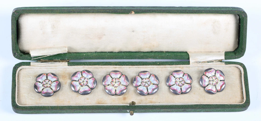 A set of six Edwardian Art Nouveau silver and enamel dress buttons