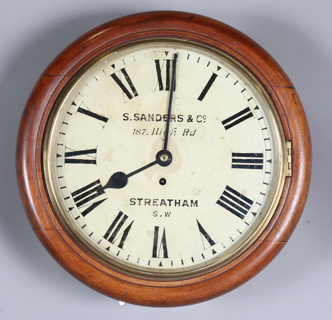 A late Victorian mahogany cased circular wall timepiece with brass