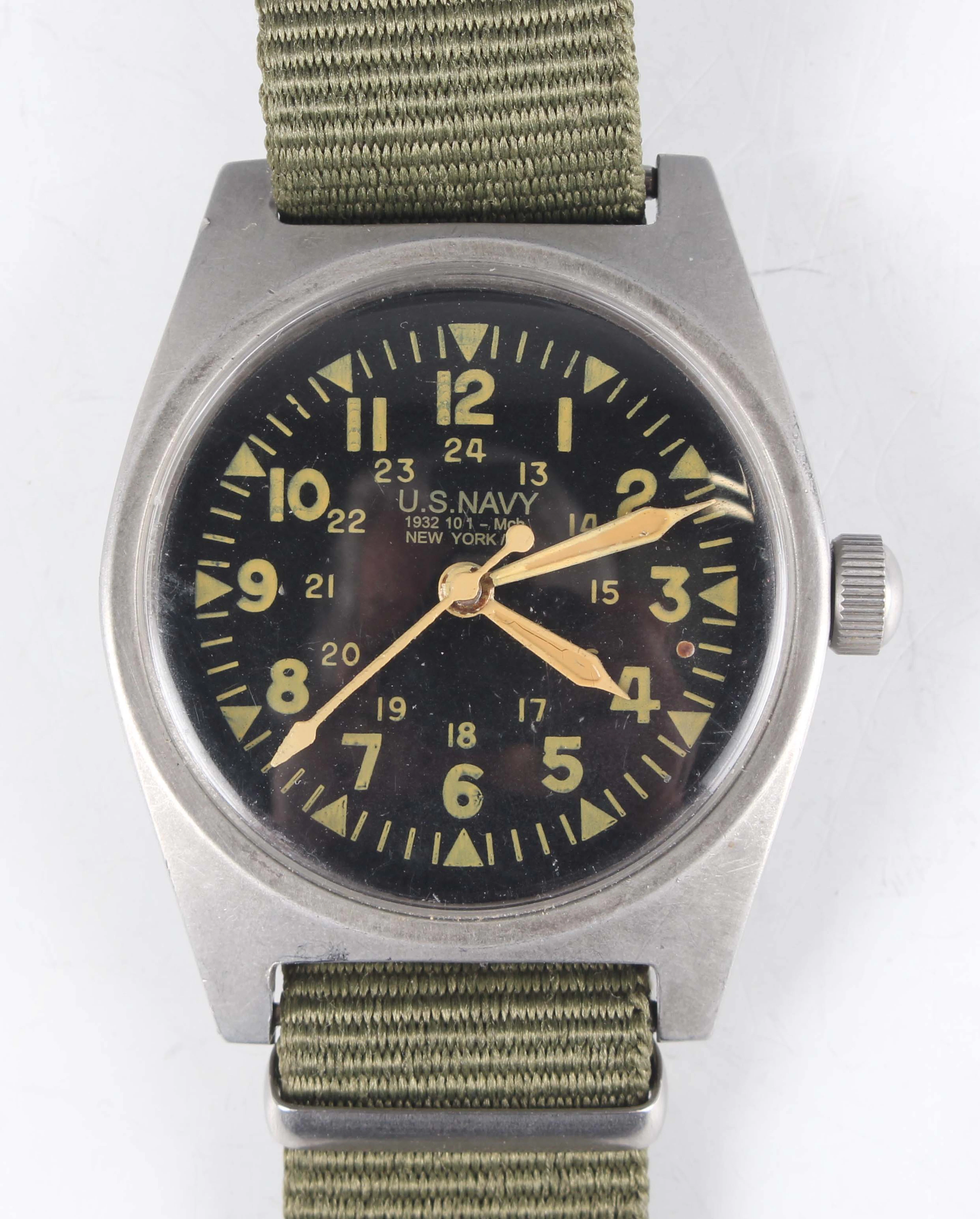 A U.S. Navy military issue steel circular cased wristwatch with signed
