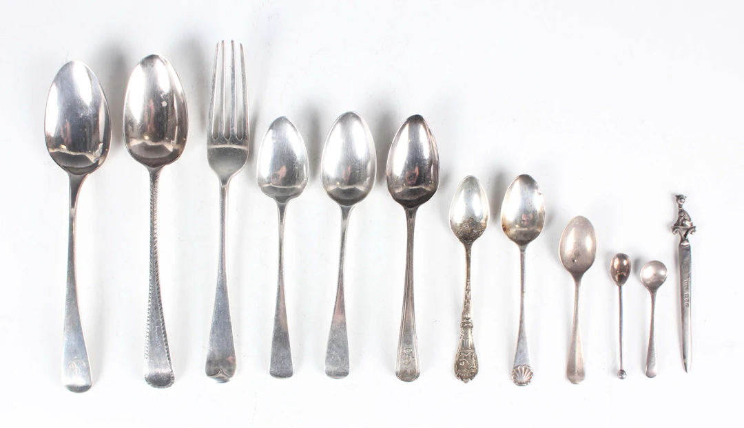 A small group of silver cutlery, including a small letter opener with