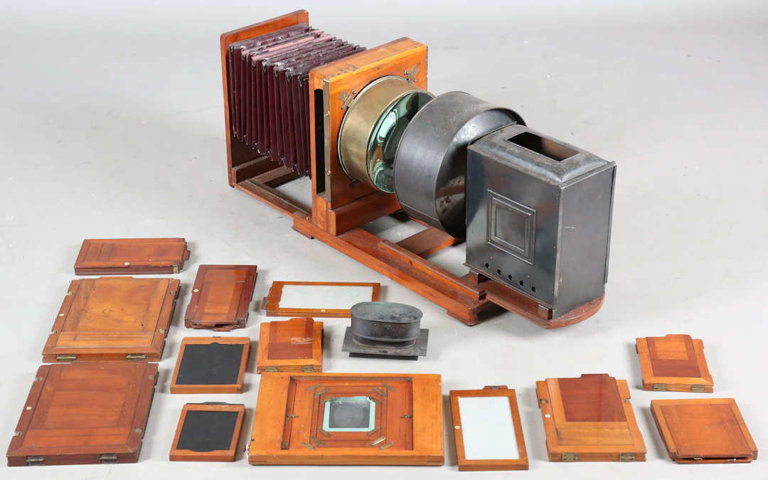 A late Victorian mahogany gilt brass and black tin photographic 'Record