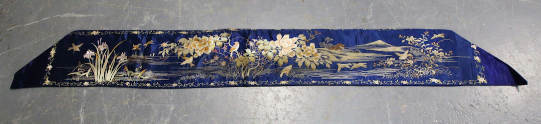 A Japanese blue silk and embroidered rectangular panel, made for the