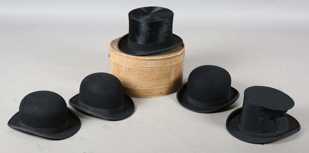 A black moleskin top hat by Dunn & Co, head circumference 60cm, together