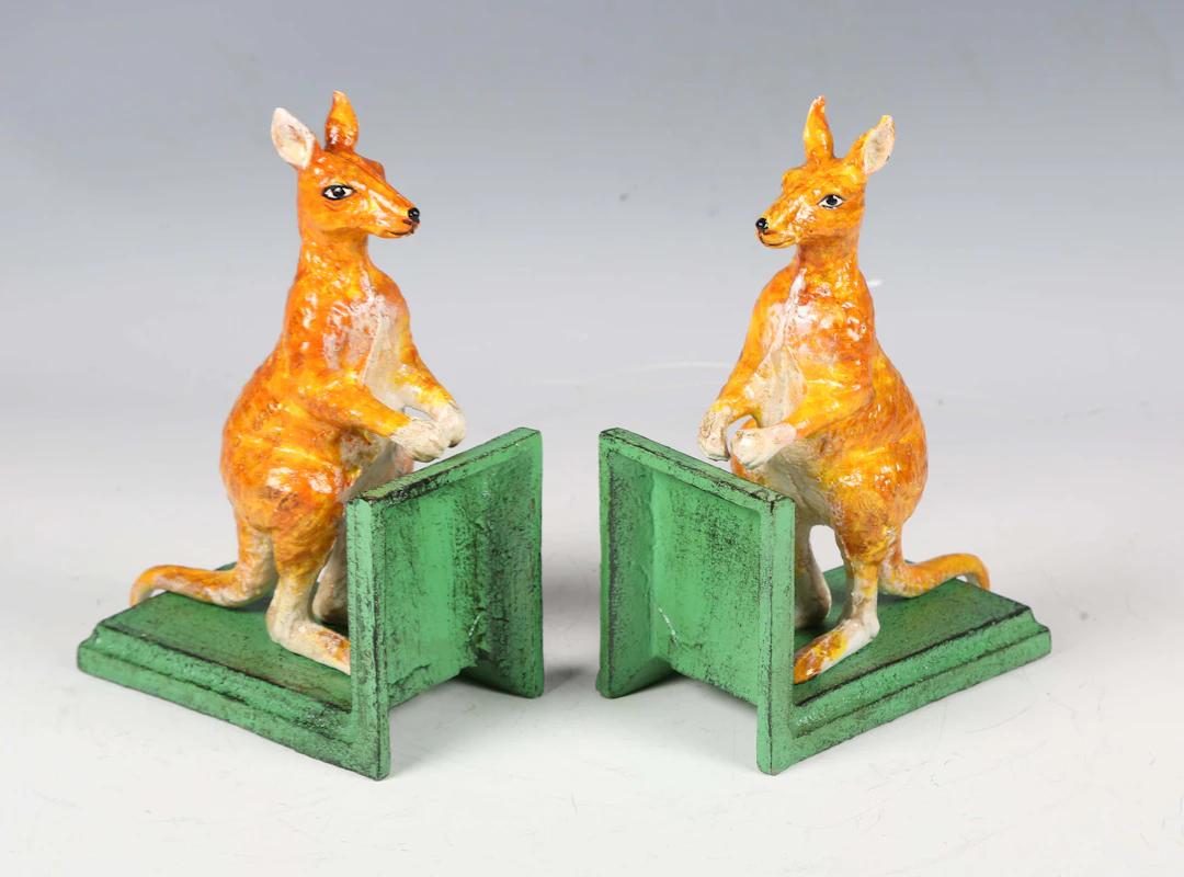 A pair of cold painted cast iron bookends, each with a kangaroo surmount