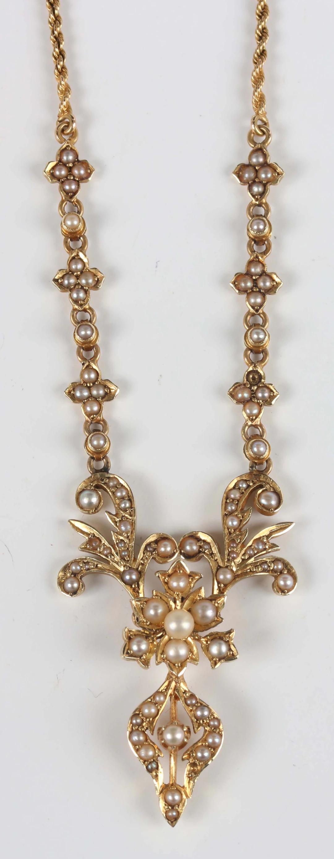 A late Victorian gold and seed pearl necklace, the front with scroll