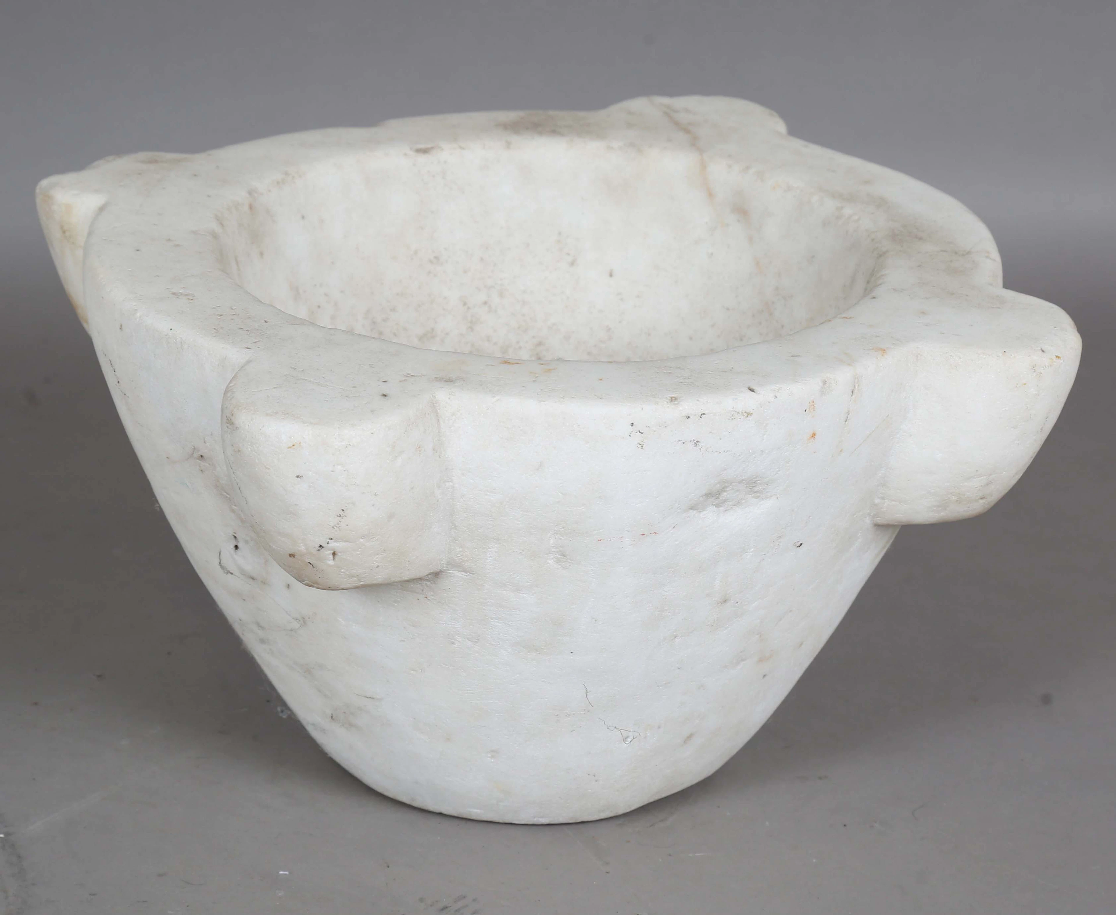 A large white marble mortar with lobed sides, width 39cm. Provenance: