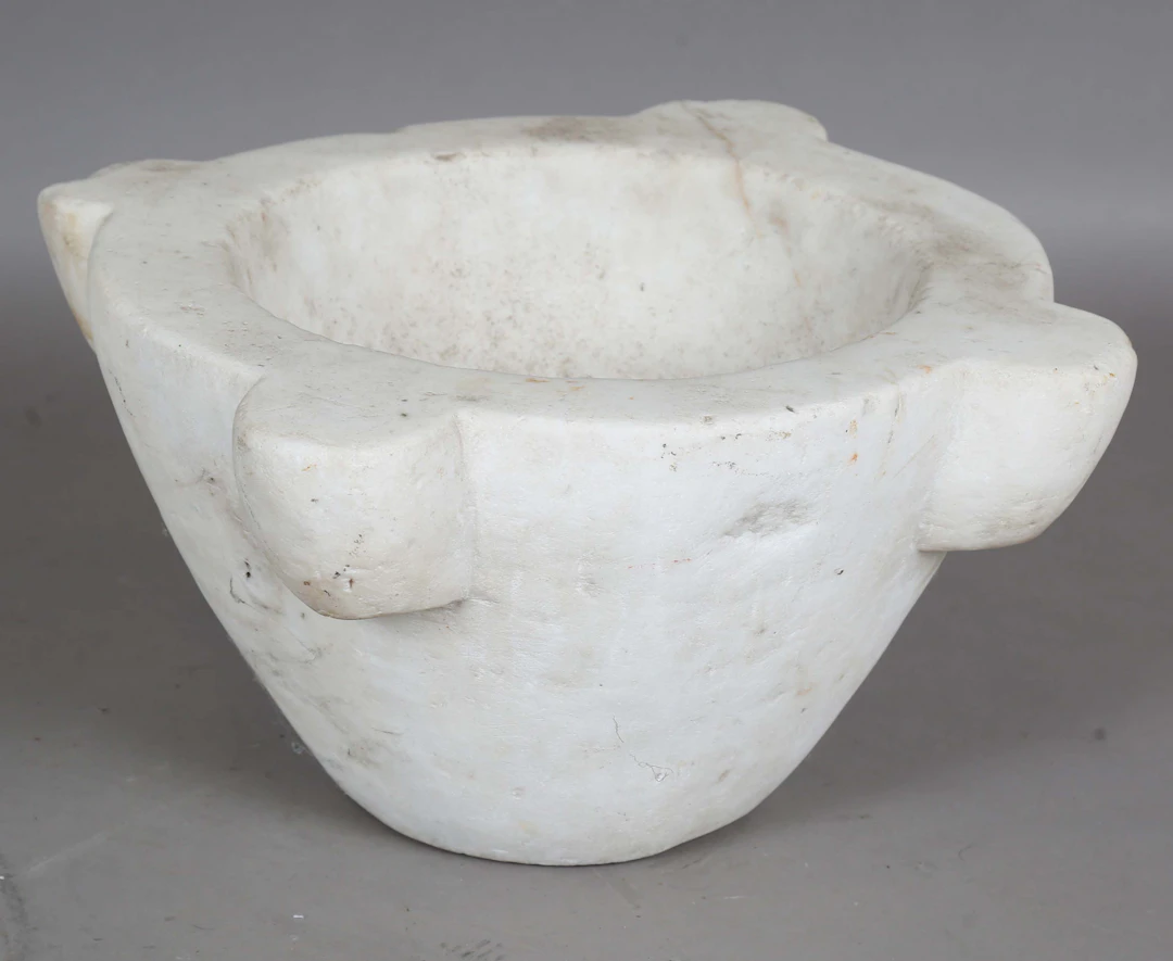 A large white marble mortar with lobed sides, width 39cm. Provenance: