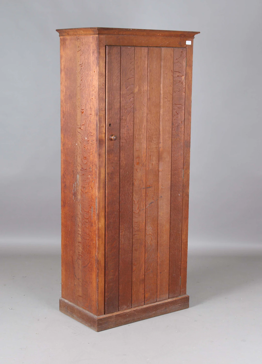 An early 20th century Arts and Crafts oak cupboard by Heal & Son Ltd