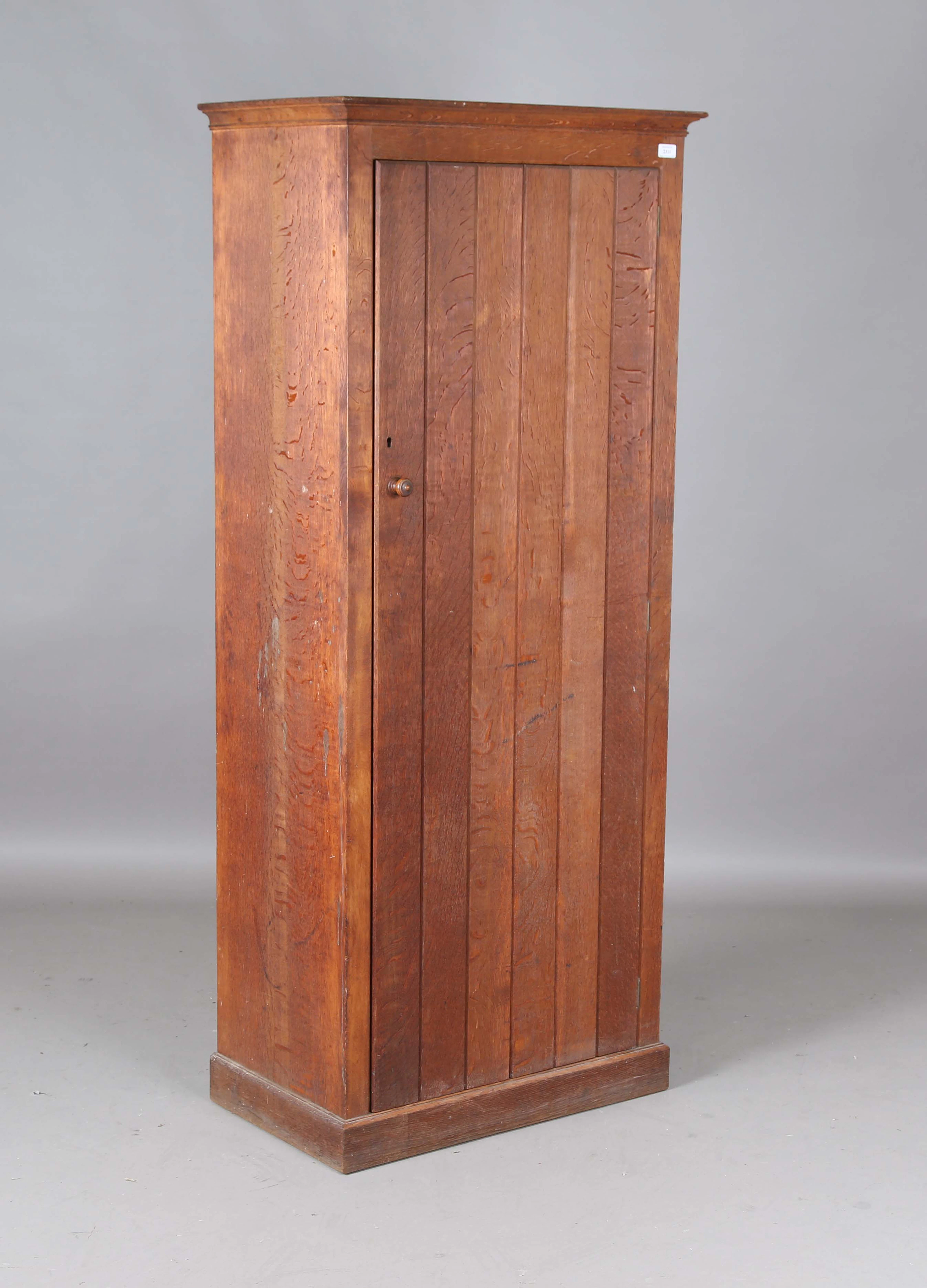 An early 20th century Arts and Crafts oak cupboard by Heal & Son Ltd