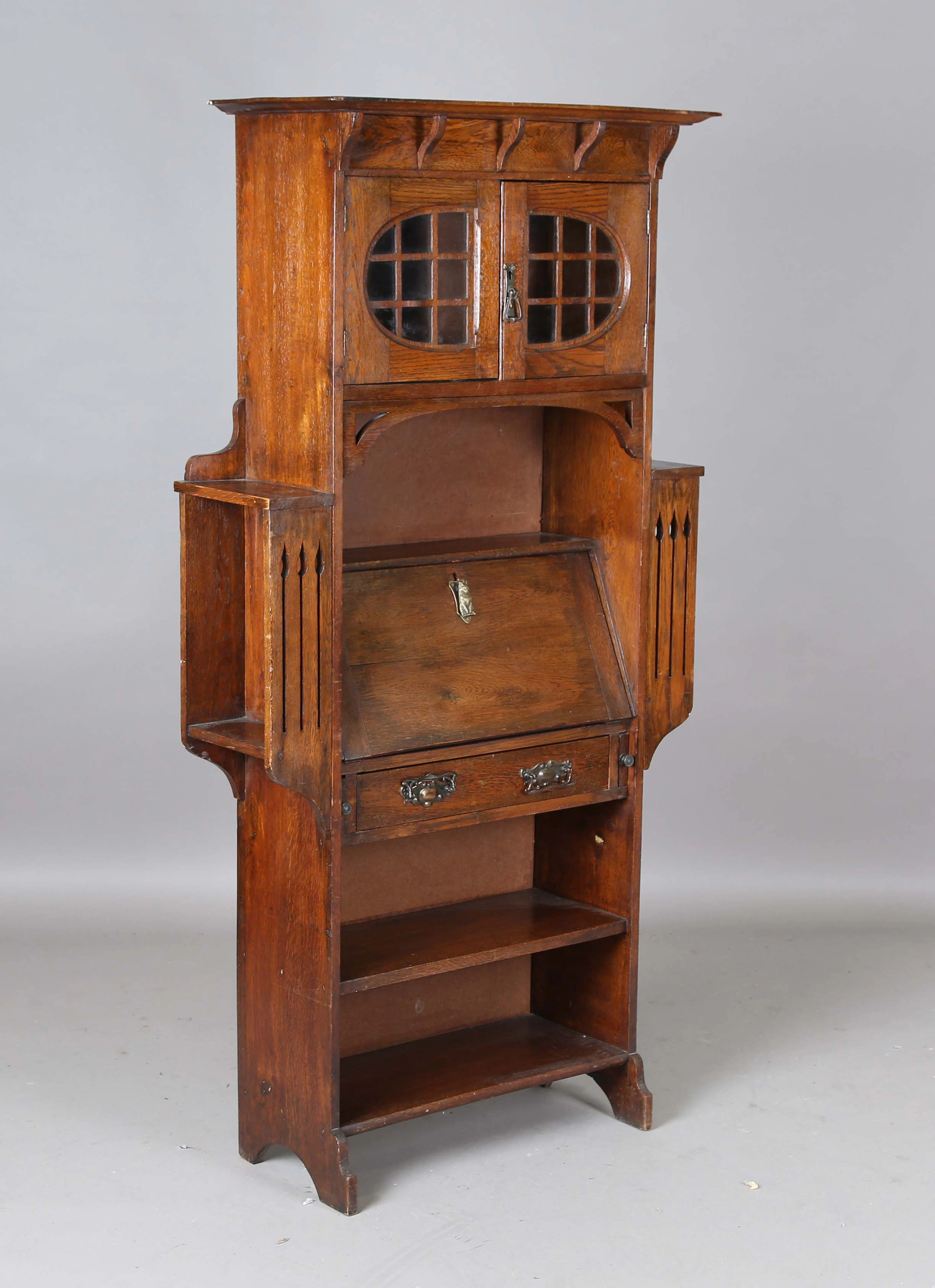 An Edwardian Arts and Crafts oak bureau bookcase, height 173cm, width