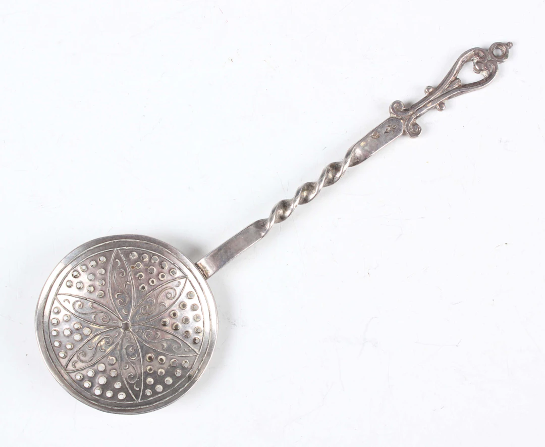 A 17th century Dutch miniature toy silver skimming spoon, the pierced