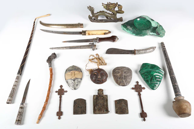 A mixed group of ethnic items, including two carved masks, two daggers