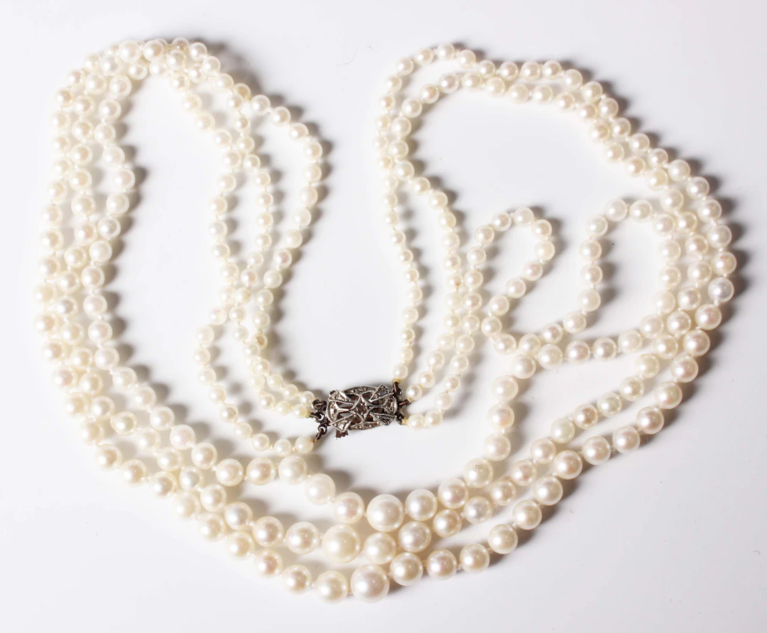 A three row necklace of graduated cultured pearls on a white gold