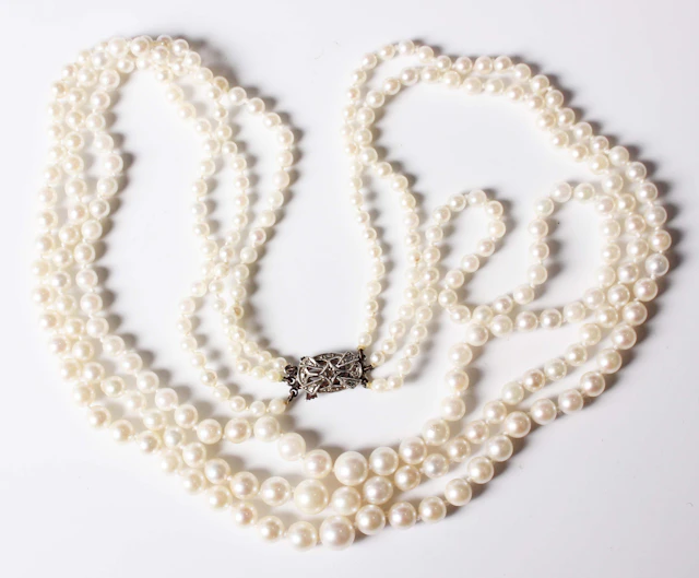 A three row necklace of graduated cultured pearls on a white gold