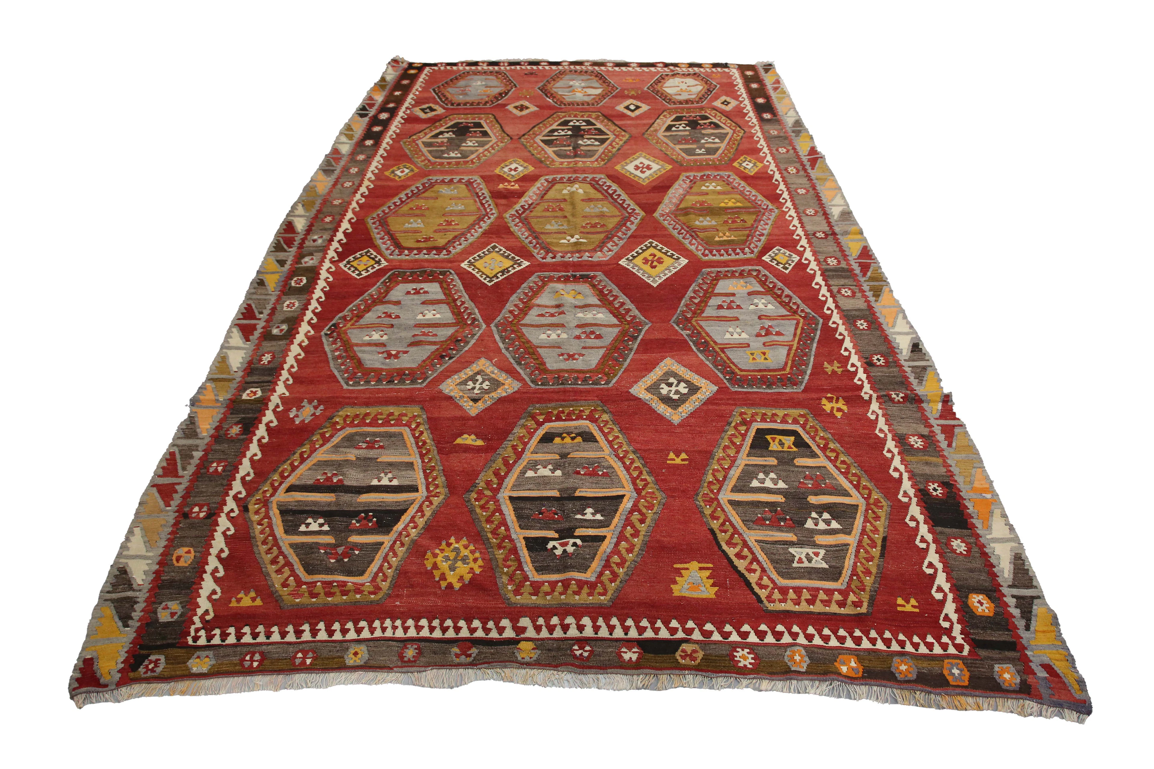 A large Turkish kilim carpet, mid-20th century, the shaded red field