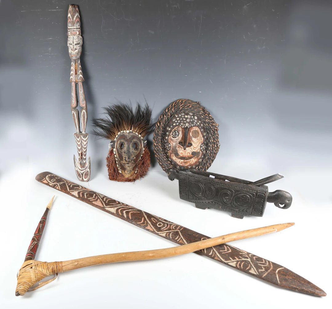 A group of Papua New Guinea artefacts, comprising two masks, a sceptre