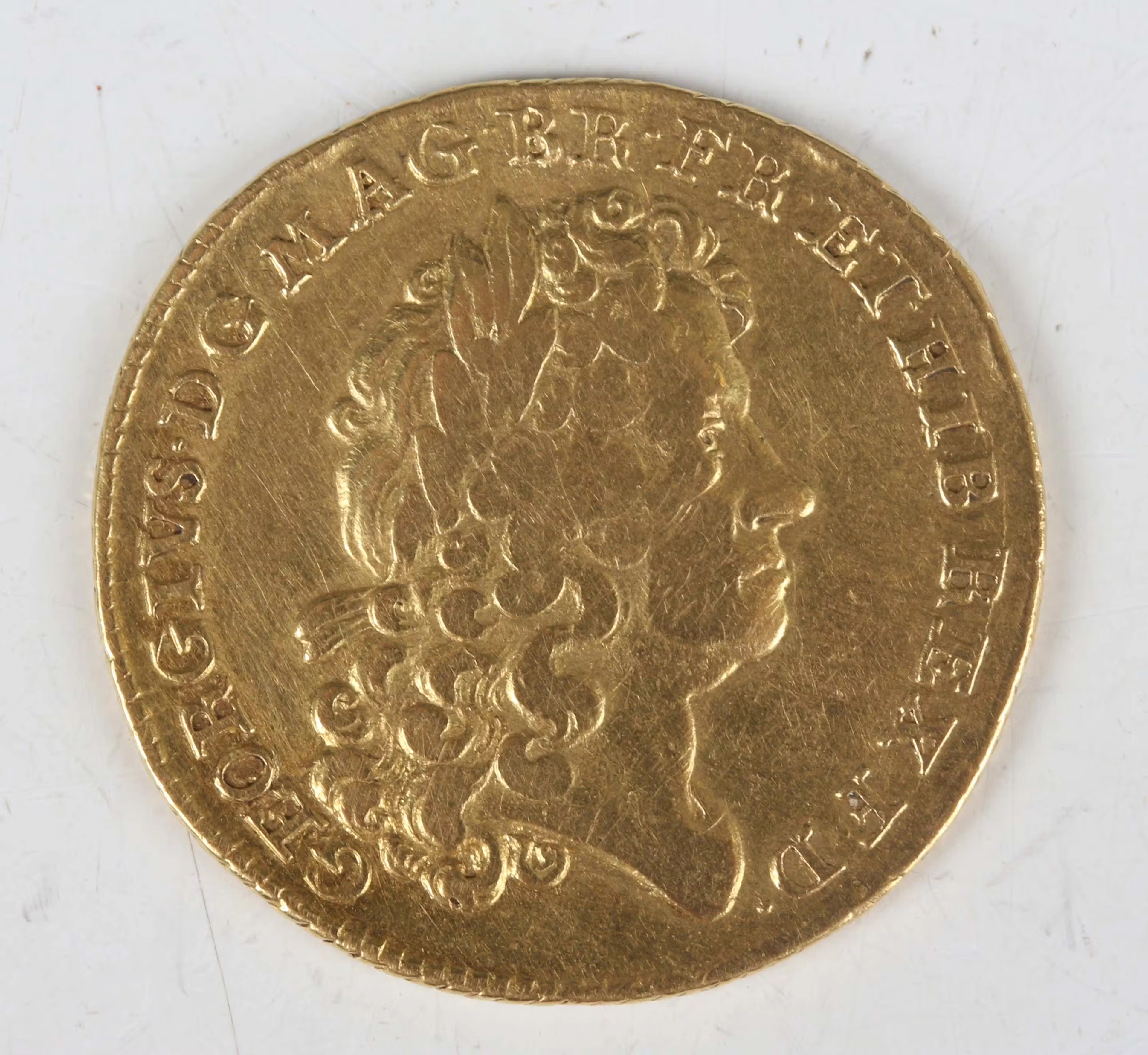 A scarce George I guinea 1714, first laureate head, Sp 3628 (good/fine).