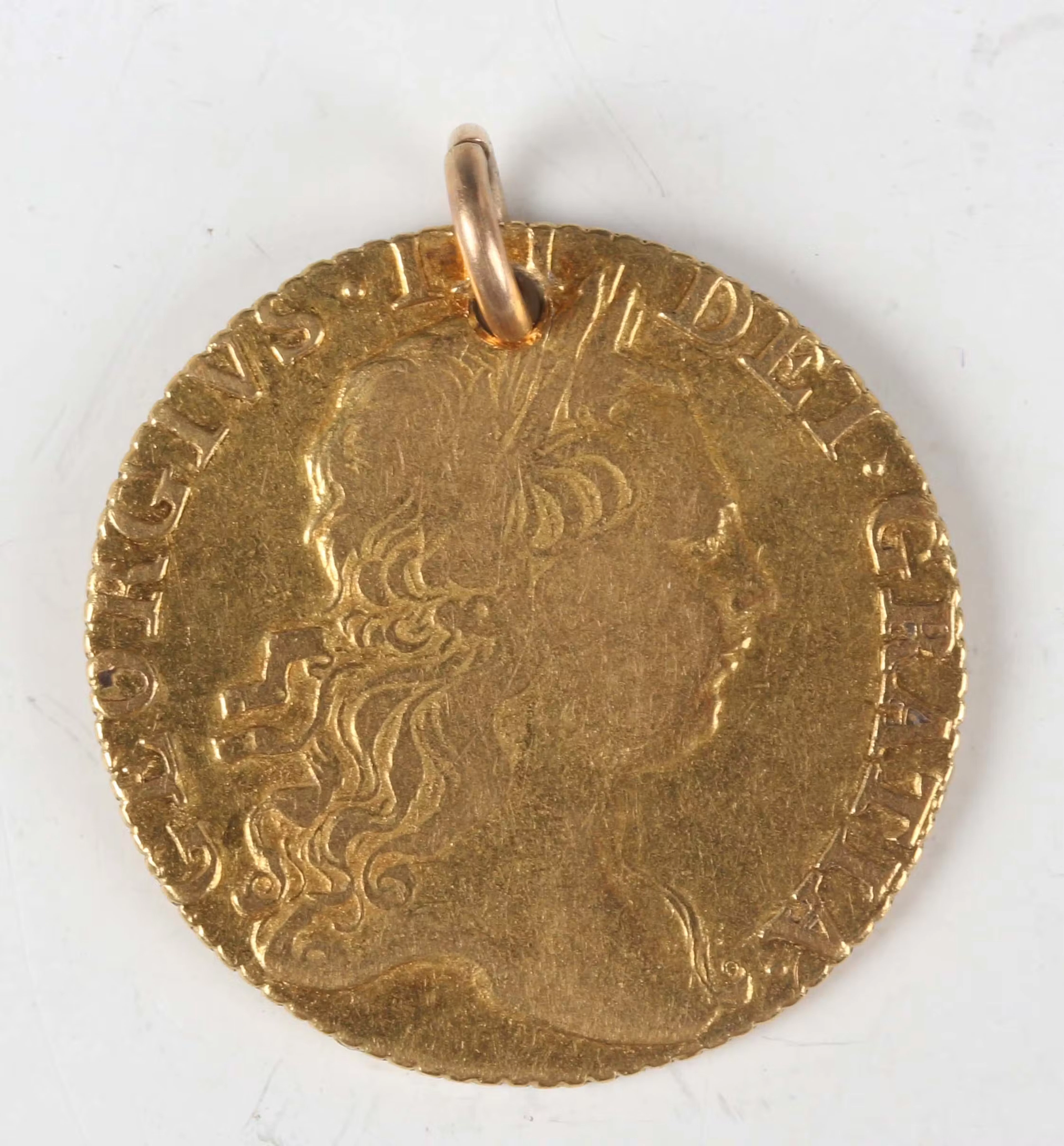 A George III guinea 1772, third laureate head, crowned shield of arms