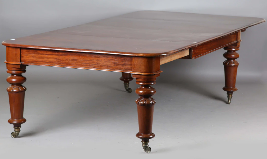 A large mid-Victorian mahogany extending dining table, the top with