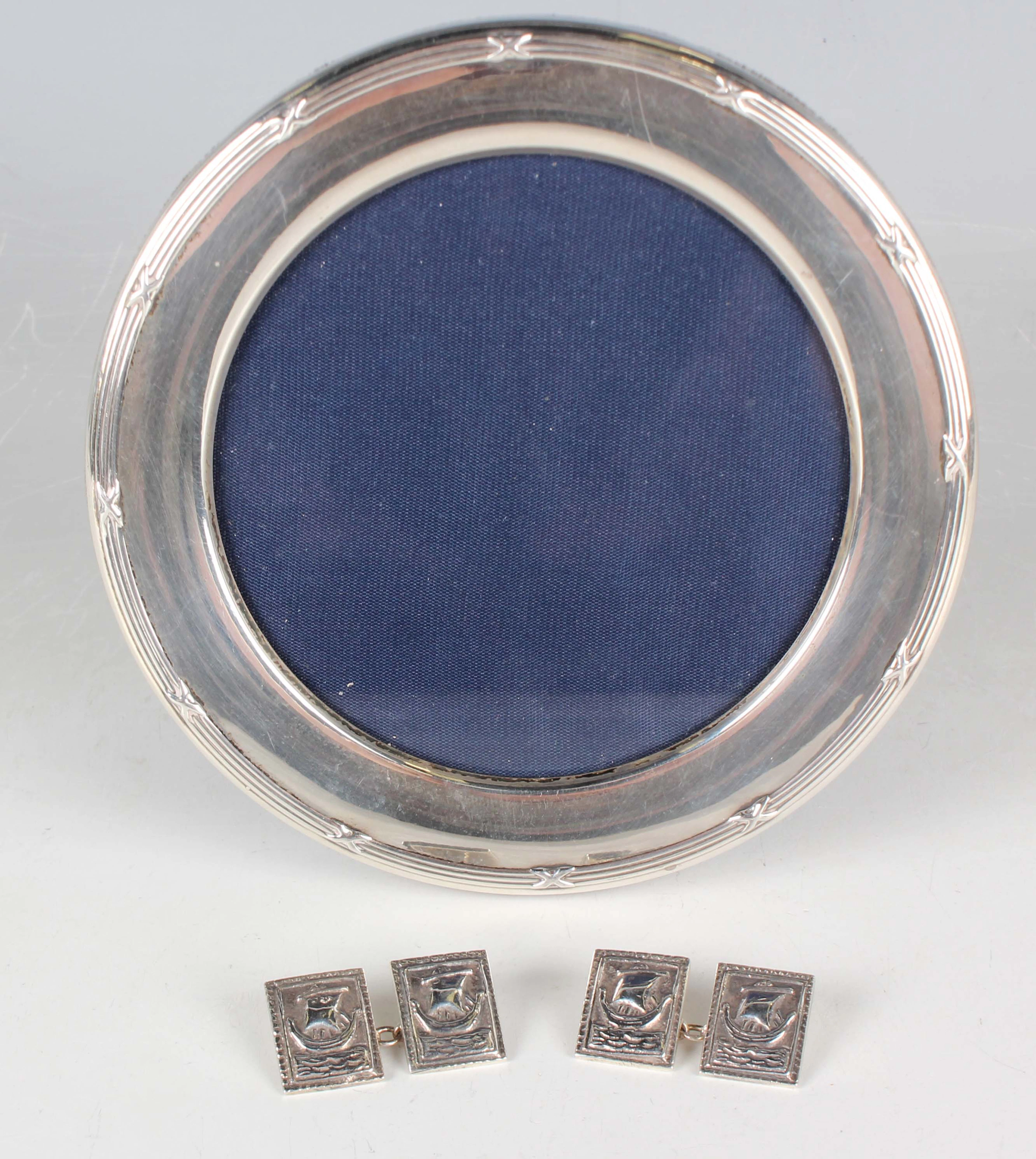 An Elizabeth II silver mounted circular photograph frame with ribbon