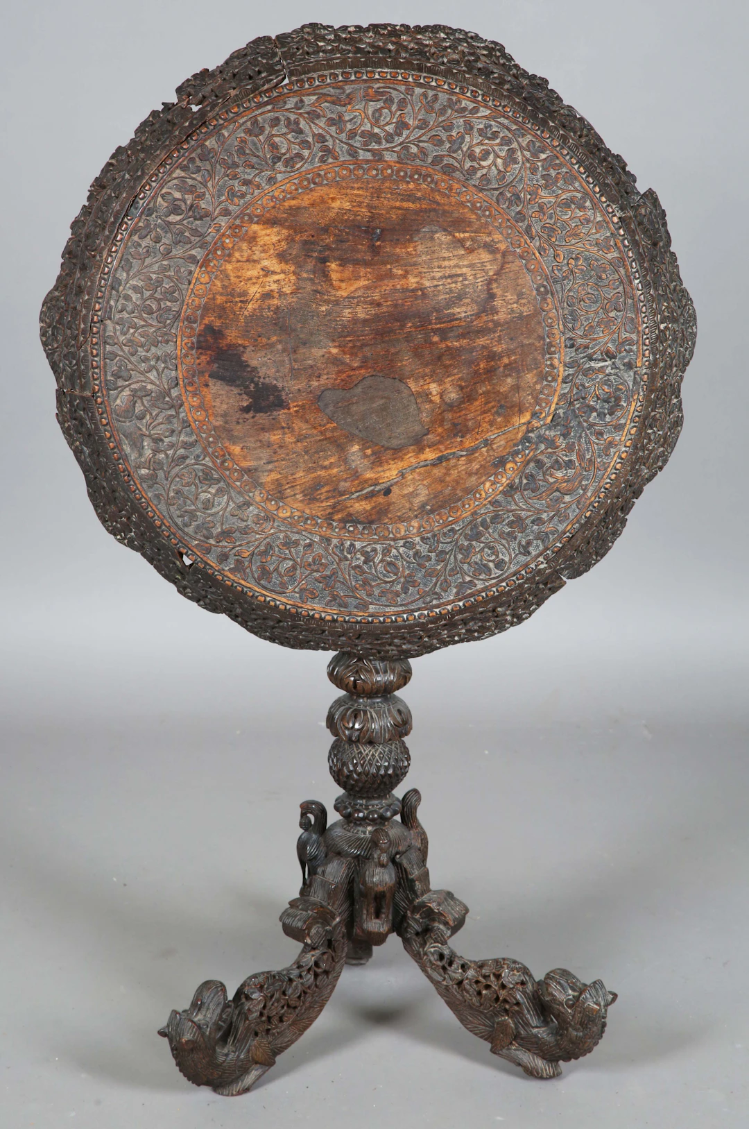 A 19th century Burmese carved and pierced circular wine table, profusely