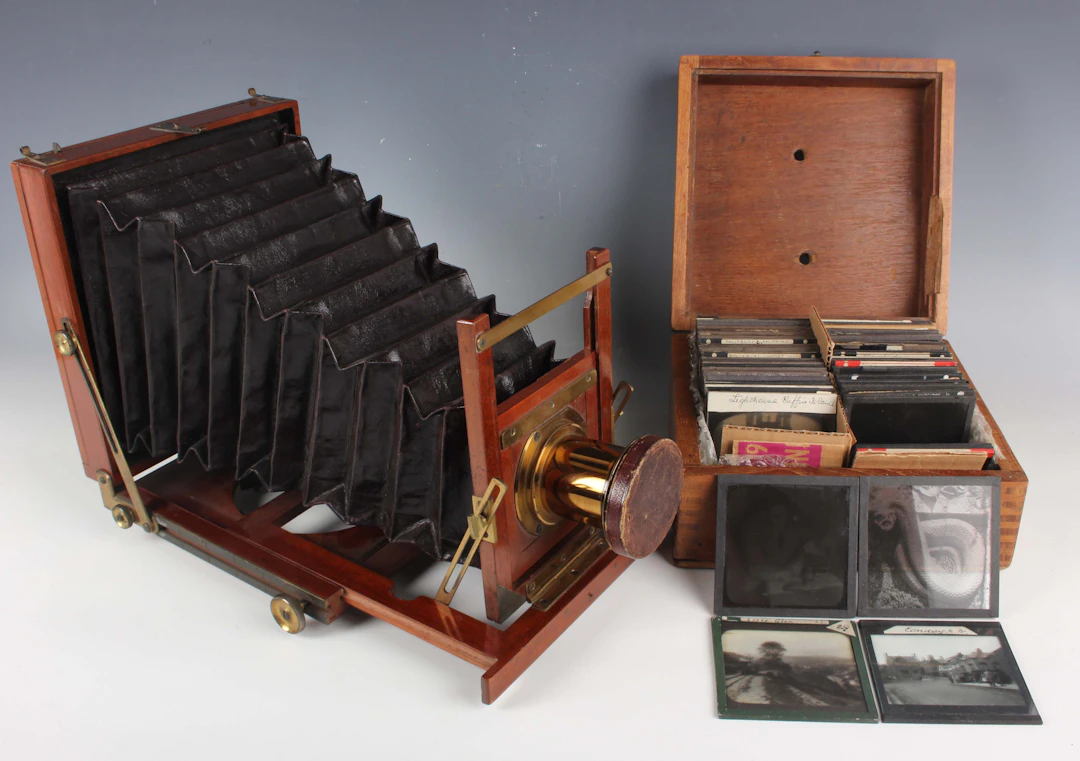 A late Victorian mahogany and lacquered brass folding plate camera