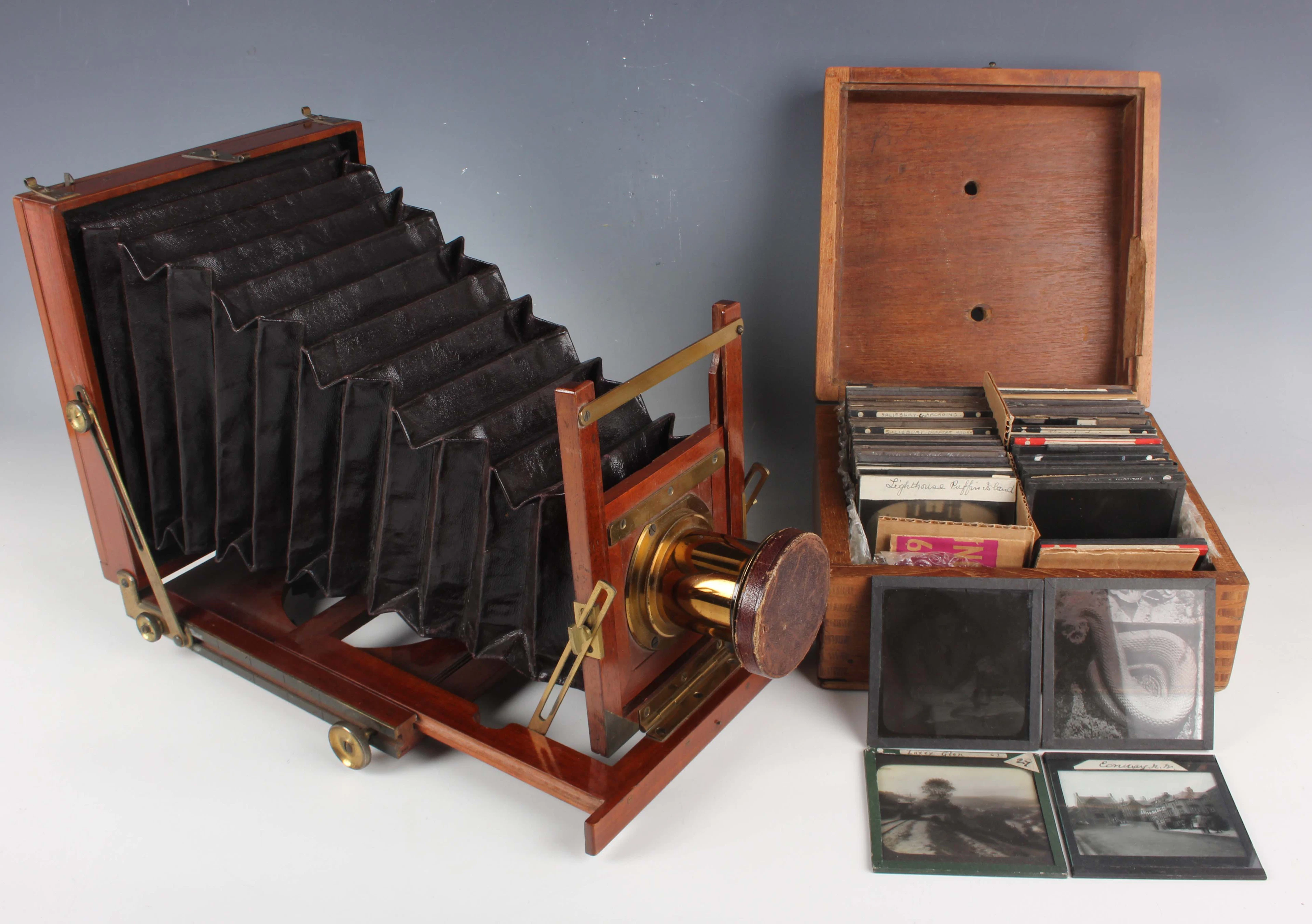 A late Victorian mahogany and lacquered brass folding plate camera