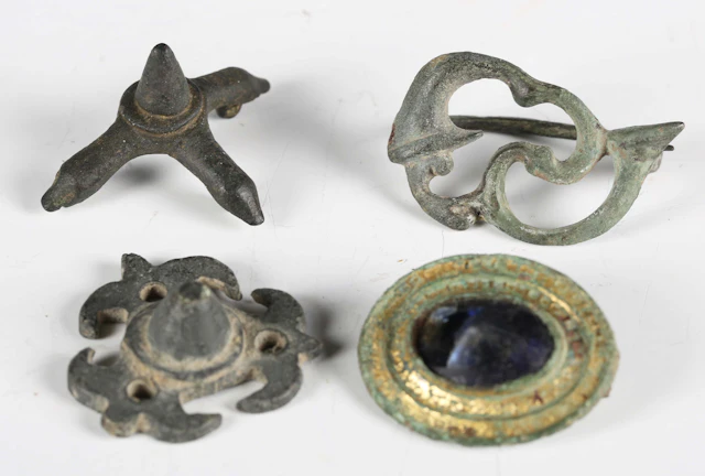 An ancient Roman gilded copper alloy oval disc brooch with inset amethyst