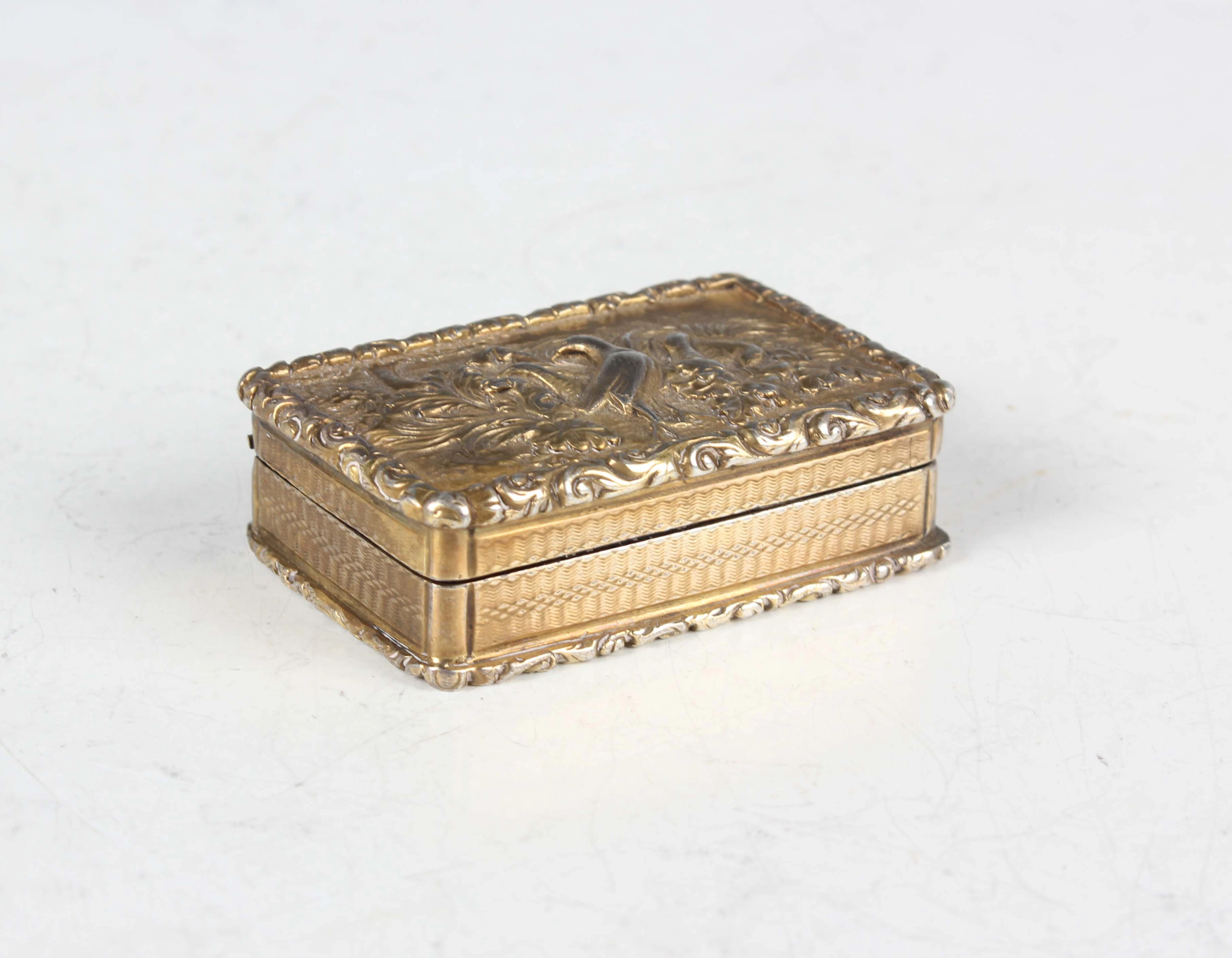A William IV silver gilt rectangular vinaigrette, the hinged lid decorated