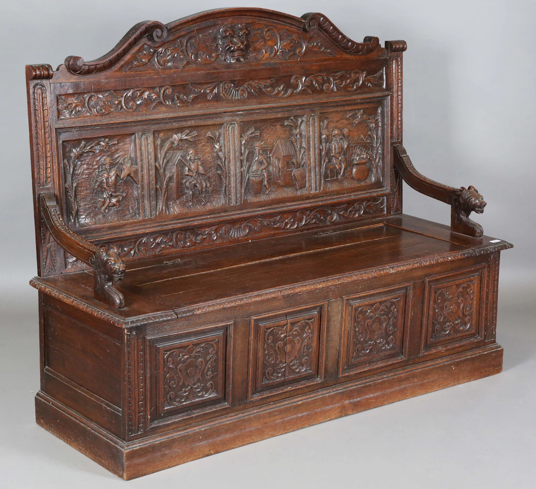 A late 19th century Tudor Revival oak box seat hall bench, the arched