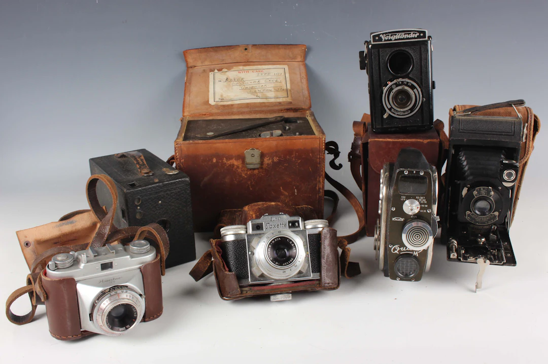 A group of assorted cameras and accessories, including a Braun Super