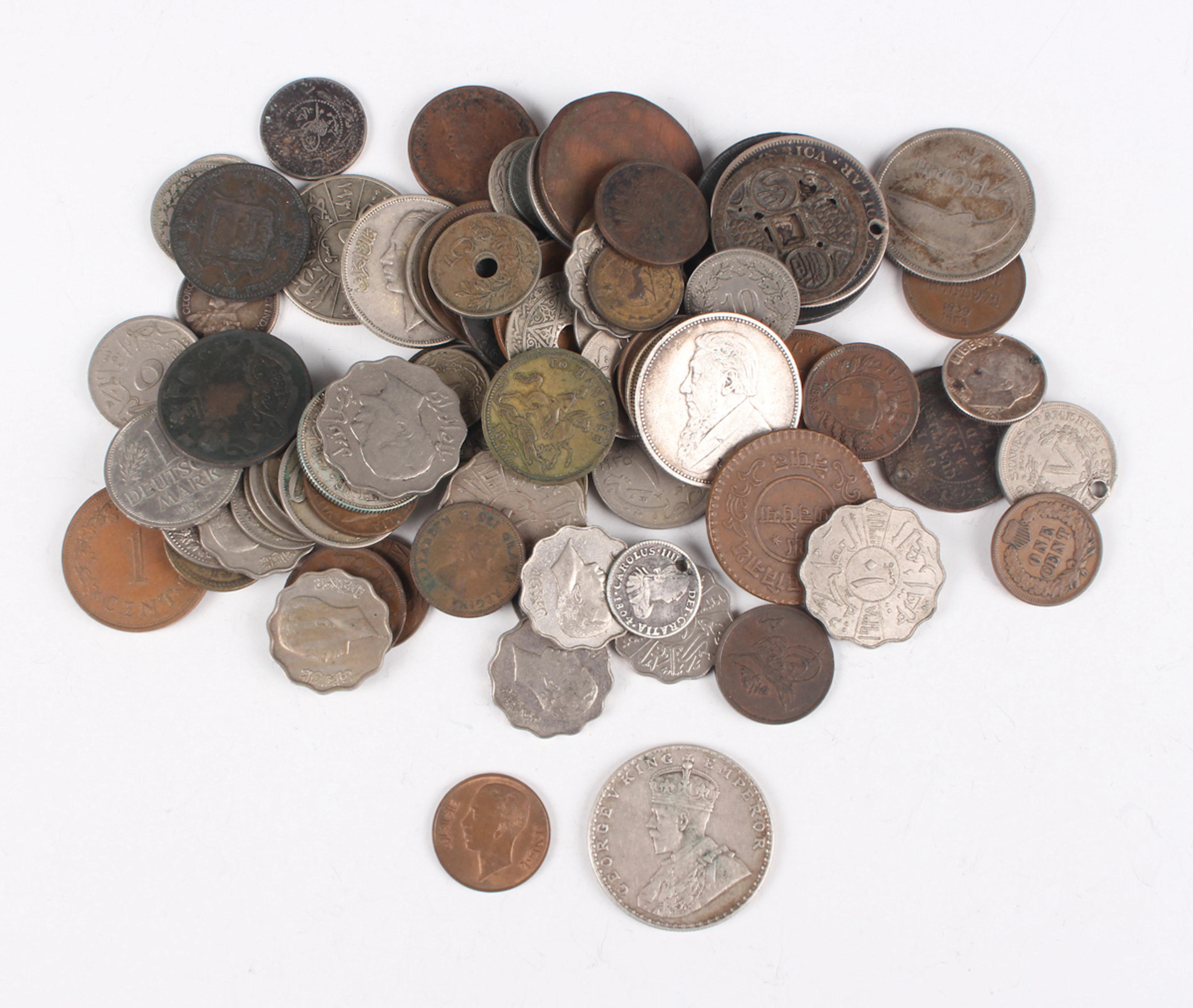 A collection of European and world coins and tokens, including a group