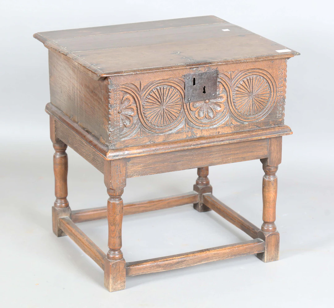 A late 17th/early 18th century oak bible box, the front carved with